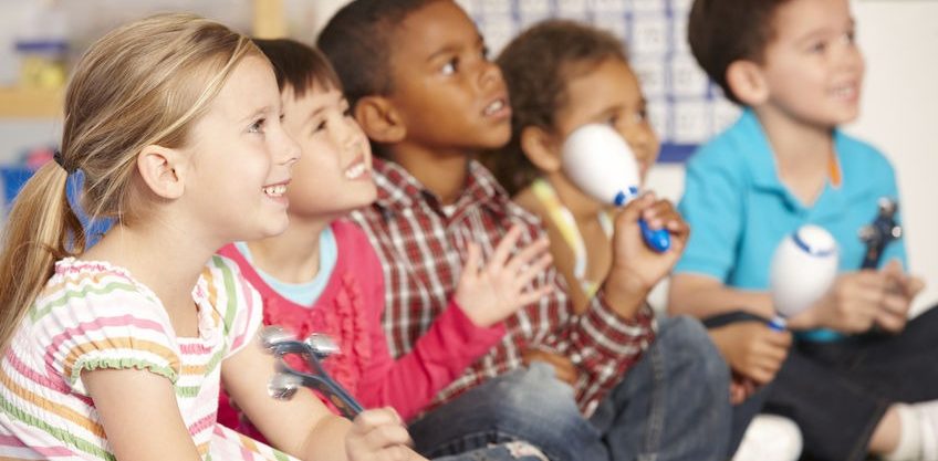Group Of Elementary Age Schoolchildren In Music Class With Instruments